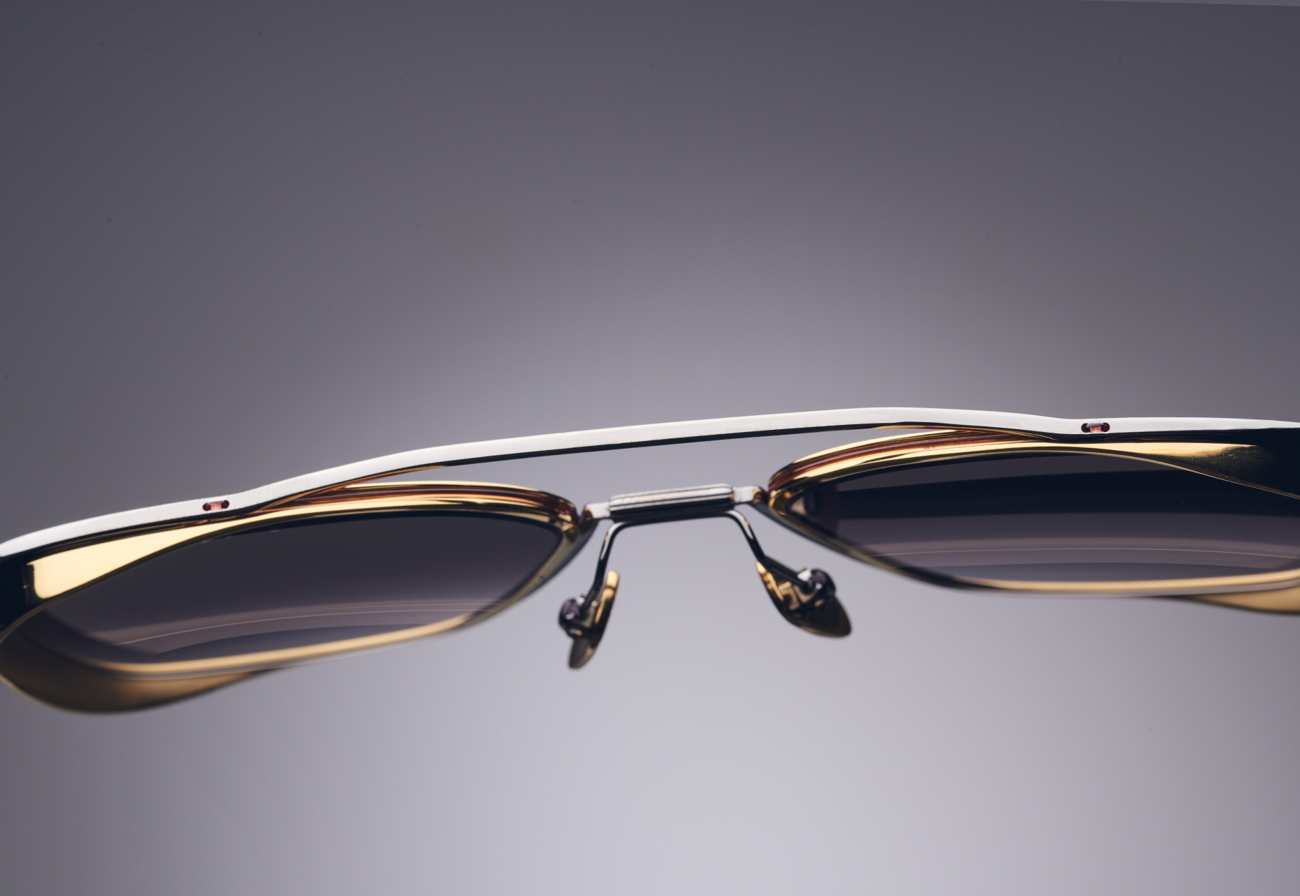SINGLE TITANIUM STRUCTURE THAT WRAPS AROUND TITANIUM CUPPED LENS RIM